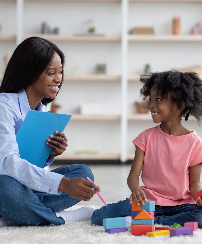 Woman and girl play with blocks