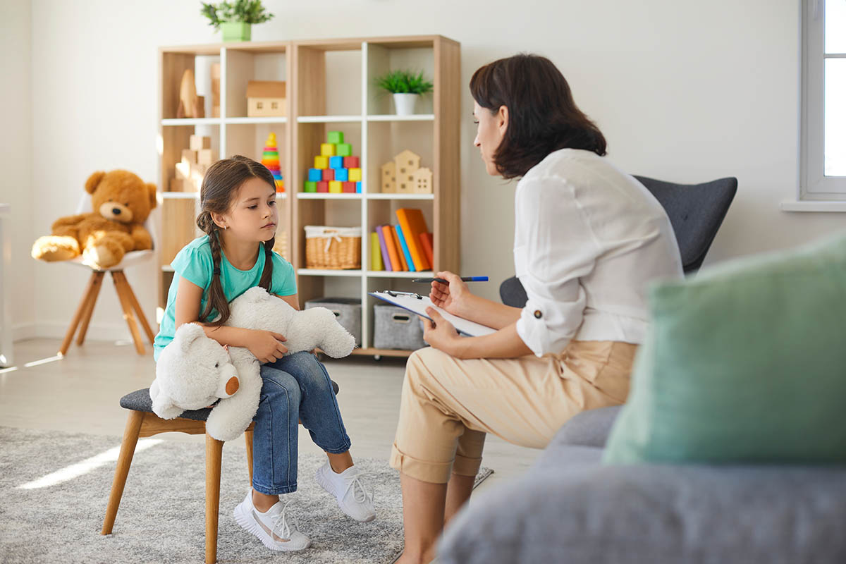 Woman speaks with child about autism