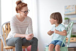 Therapist talks to child while she considers the benefits of in-home aba therapy