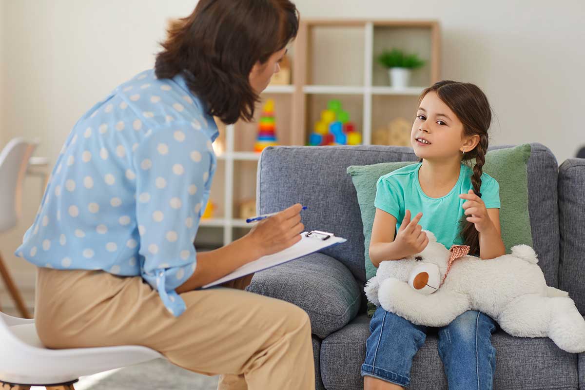 Woman talks to child during an autism diagnostic evaluation