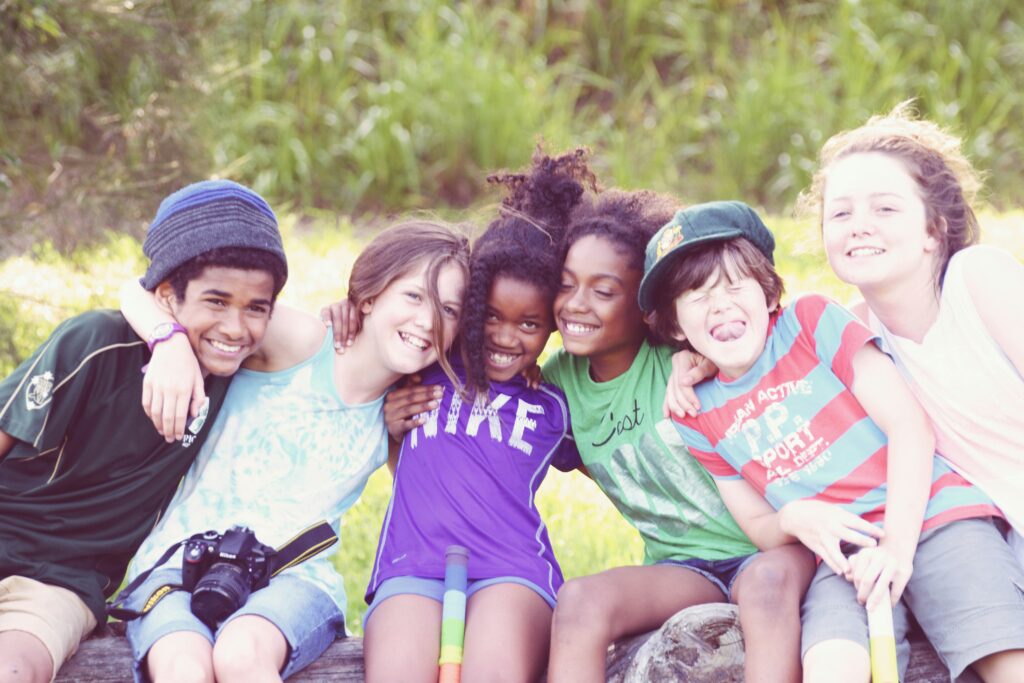 Group of children smiling and enjoying summer activities, supporting a gentle home rhythm during school breaks.