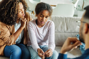 mother helping child practice life skills for autism