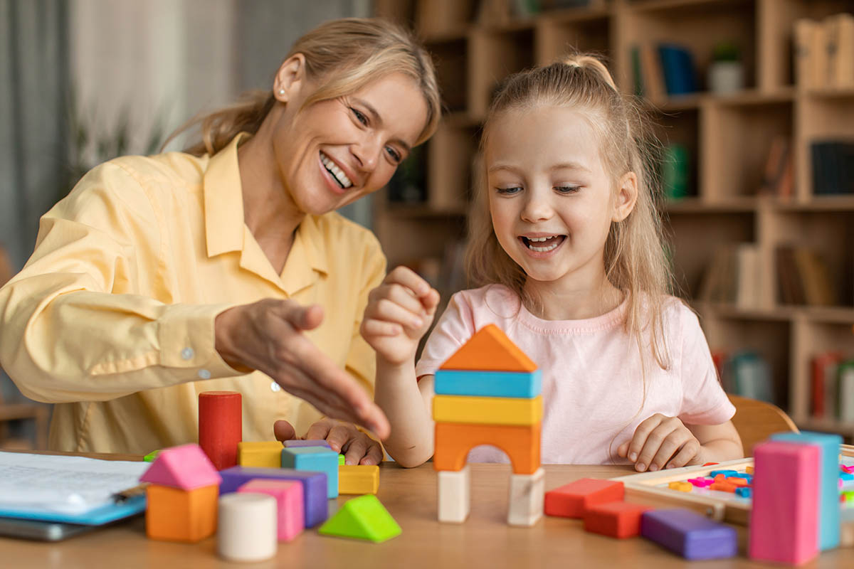 parent playing blocks with child after learning about the autism diagnostic interview-revised
