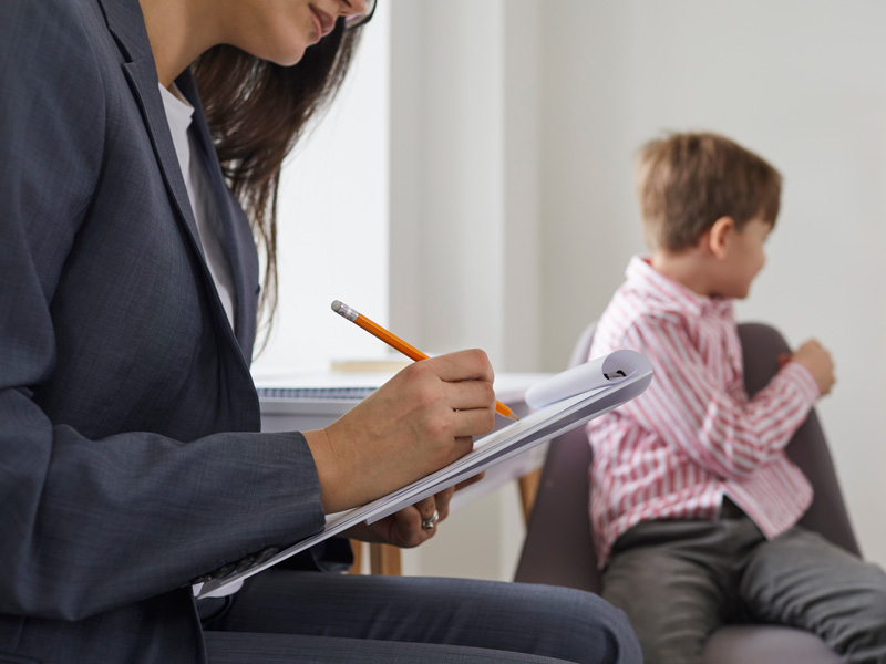 Psychiatrist evaluating young patient for Autism