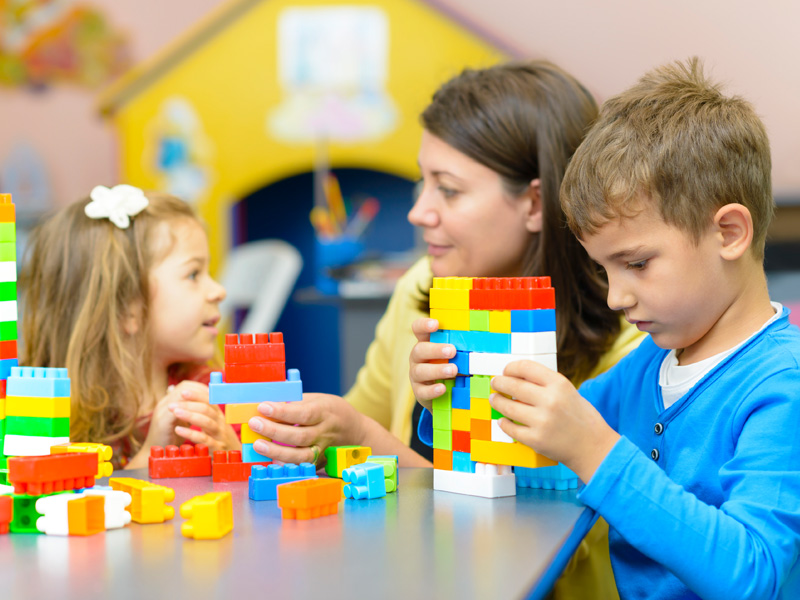 Specialist using lego blocks with child patients