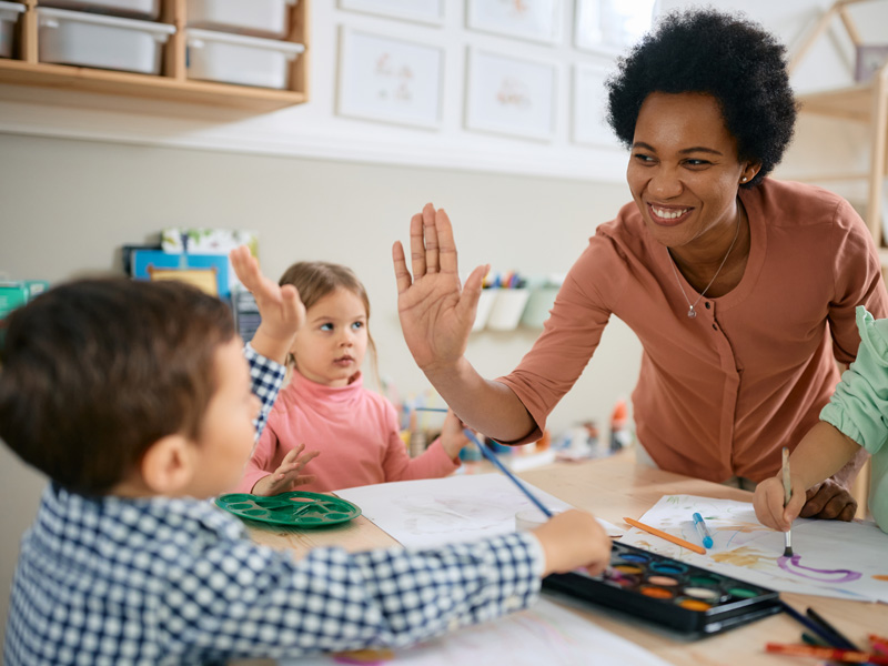 Specialist high fiving young boy patient