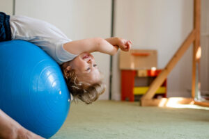 Child playing on a yoga ball