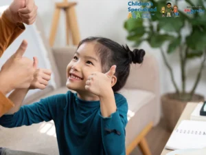 Child smiling and giving thumbs up during ABA therapy session