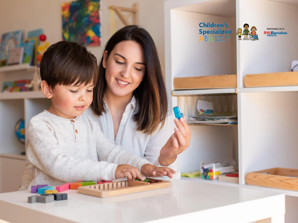 Therapist and child playing with building blocks