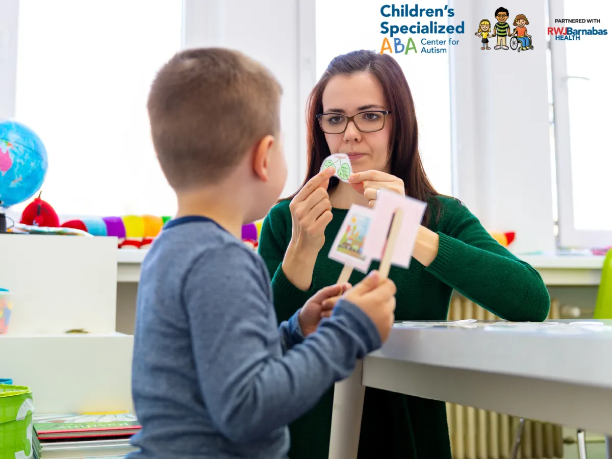 Therapist using flashcards with a child during autism therapy session