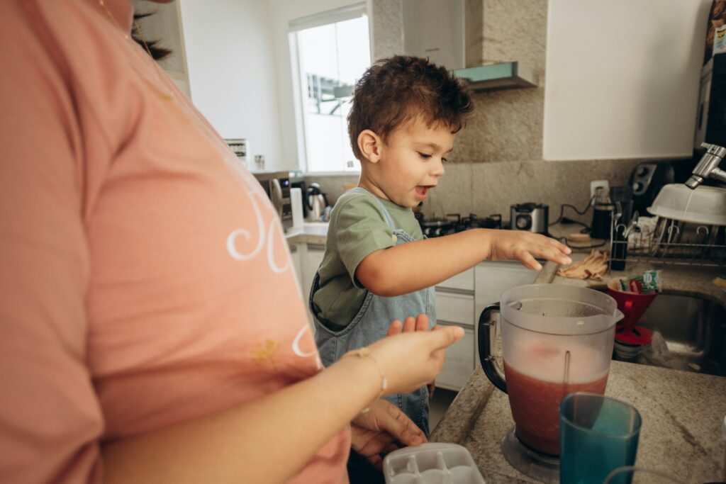 Parent and child in kitchen demonstrating reinforcement techniques for autism at home.